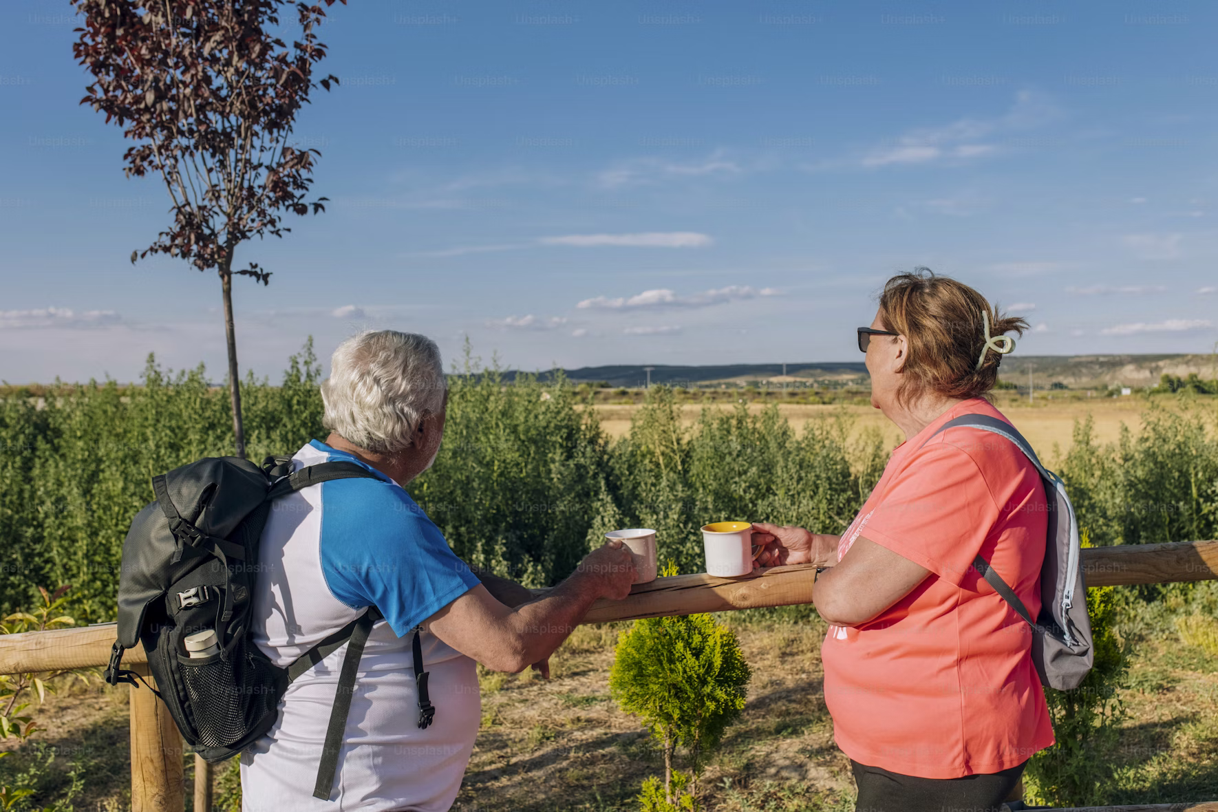 Hands gently holding soil and a small plant, metaphor for growth and care over time.